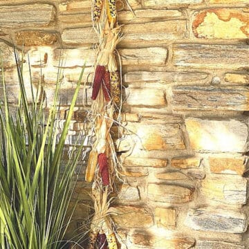 mini Indian corn and raffia hanger on stone wall
