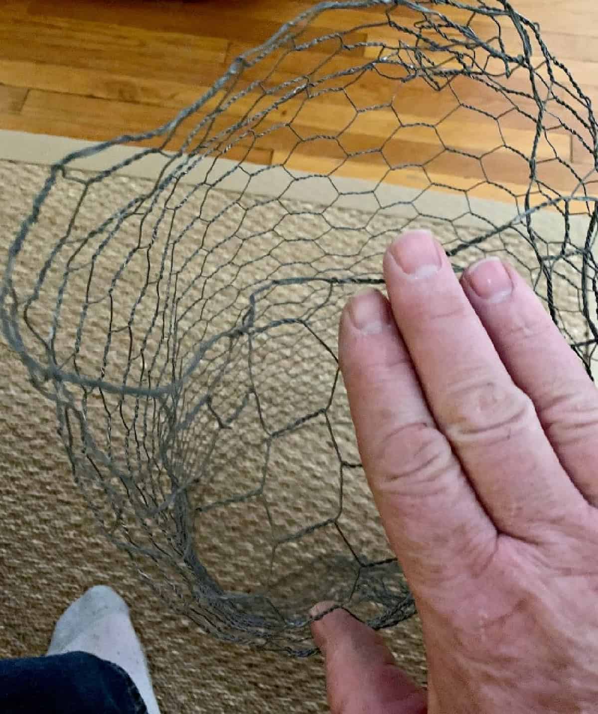 How to Make Lighted Christmas Balls (And How to Hang Them) picture folding end of chicken wire to make DIY lighted chicken wire Christmas balls