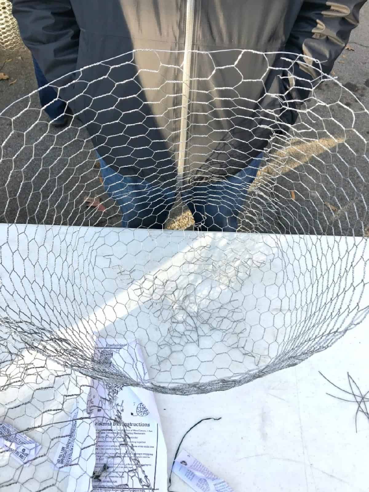 How to Make Lighted Christmas Balls (And How to Hang Them) photograph one end of chicken wire lighted ball closed in