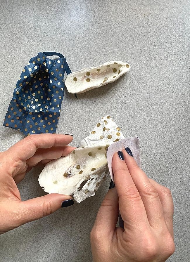 using sandpaper to sand tissue off of seashell