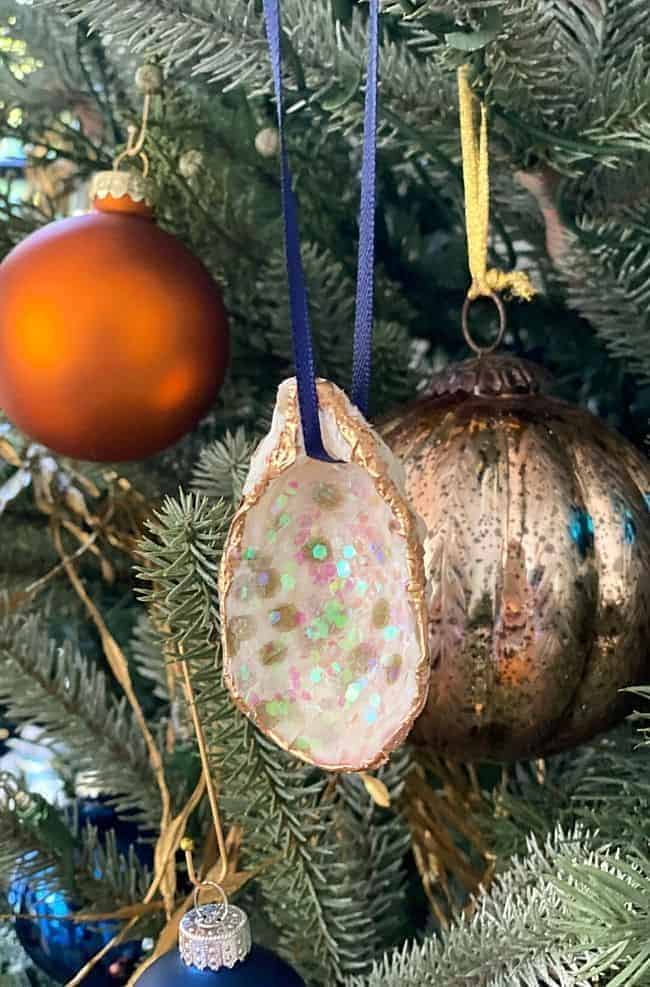 DIY seashell ornament hanging on a Christmas tree