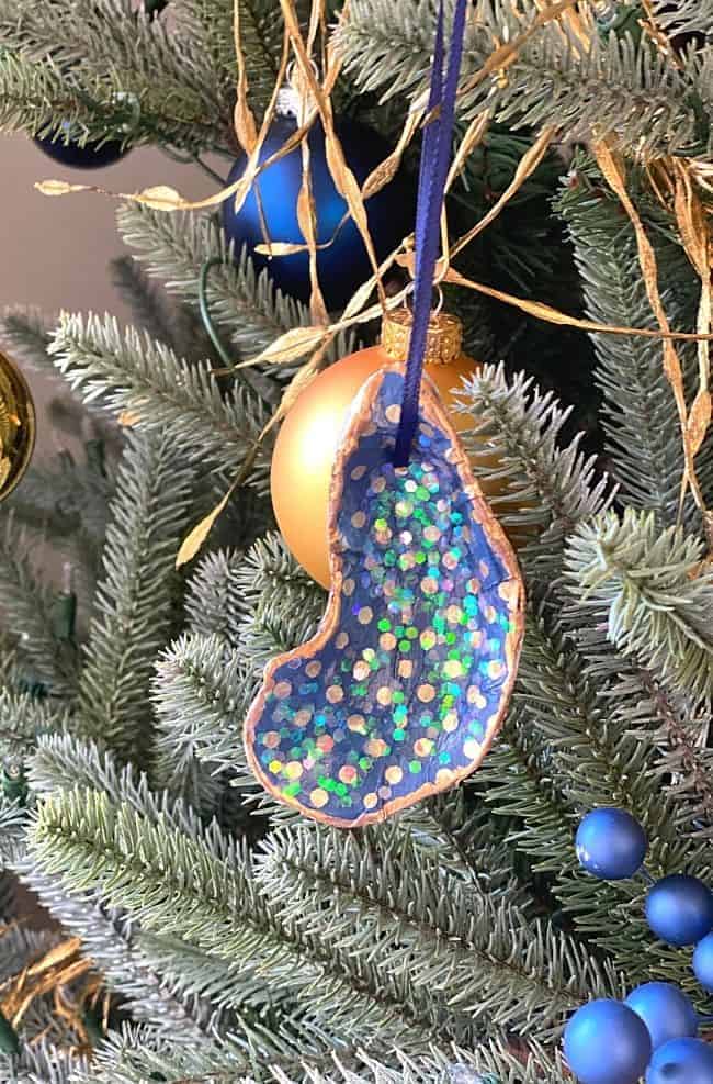 DIY seashell ornament hanging on a Christmas tree