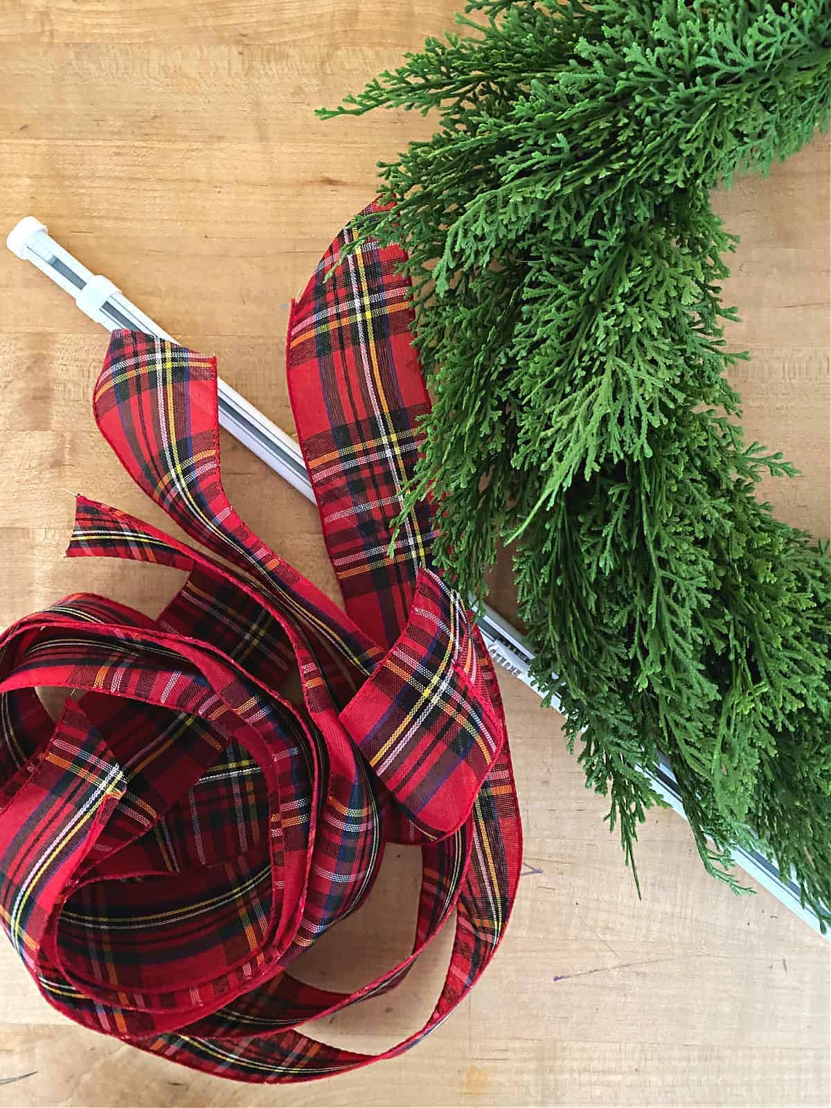 wreath, ribbon and tension rod on a butcher block