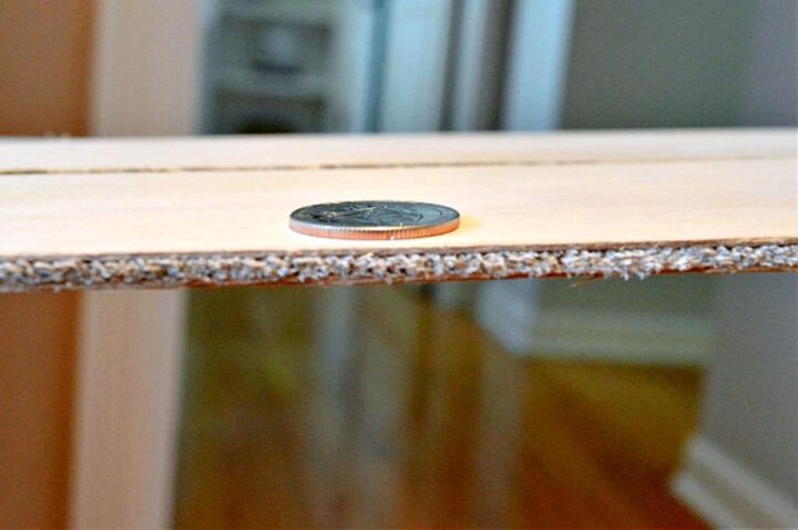 quarter on top of piece of plywood to show thickness