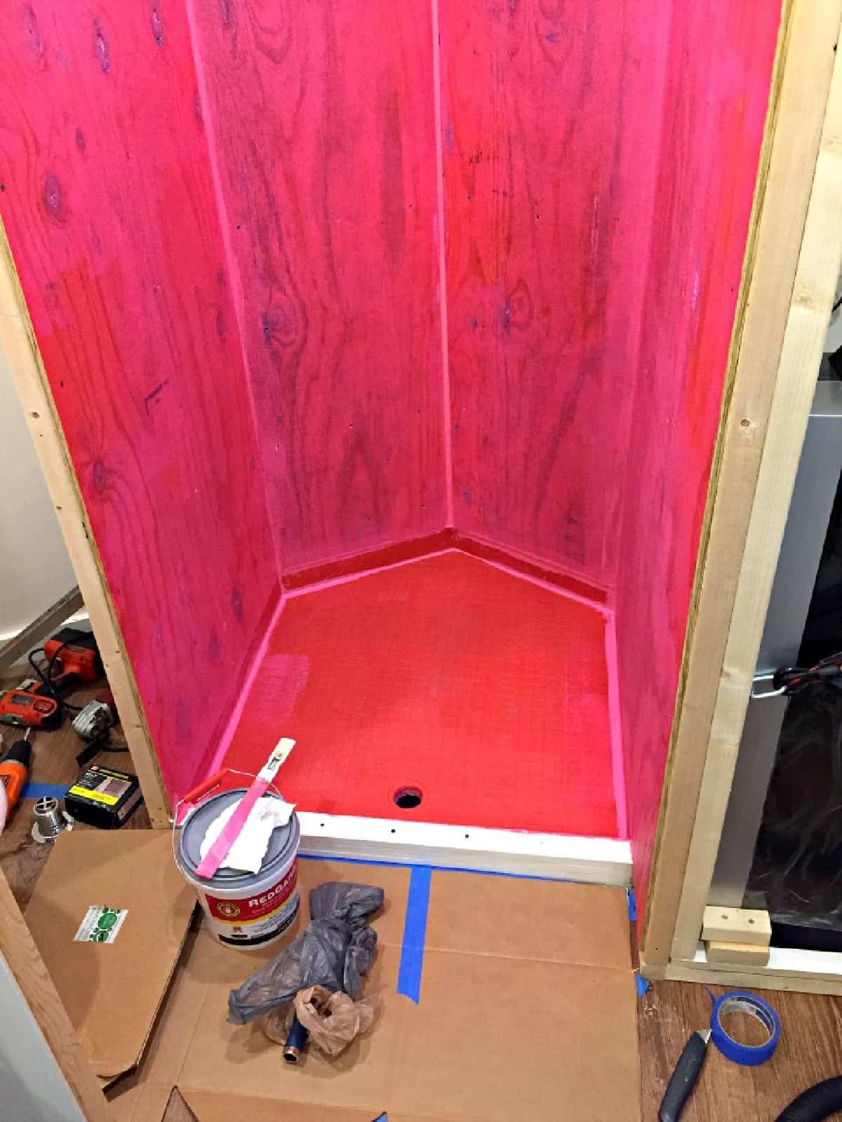DIY Wood Bath Mat pic custom built shower in cargo trailer conversion with waterproof walls in red