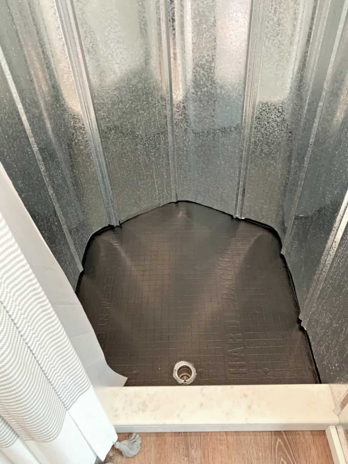 DIY Wood Bath Mat pix black painted shower floor with metal shower walls in an RV