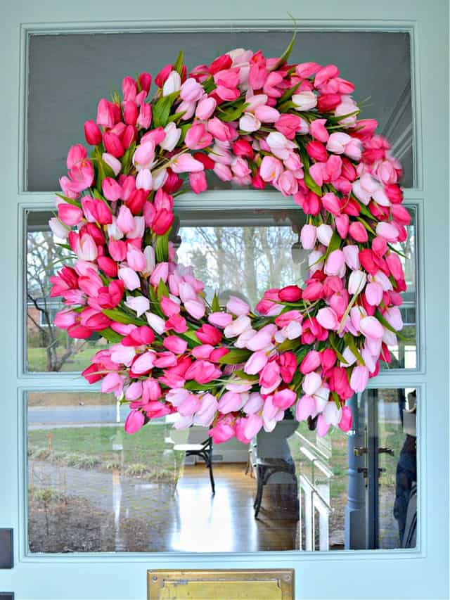 DIY spring tulip wreath hanging on turquoise front door