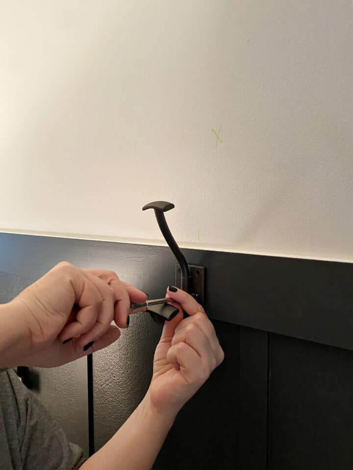 Easy Board and Batten Accent Wall hooks pic attaching coat hooks to a dark wall