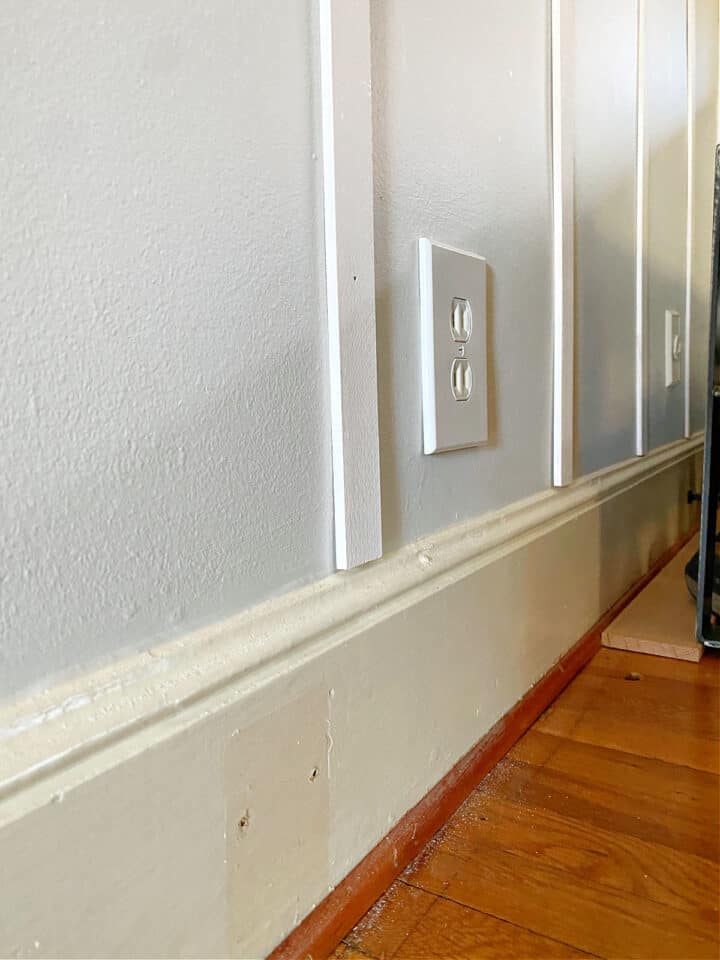 Easy Board and Batten Accent Wall photograph white wood battens resting on wall trim
