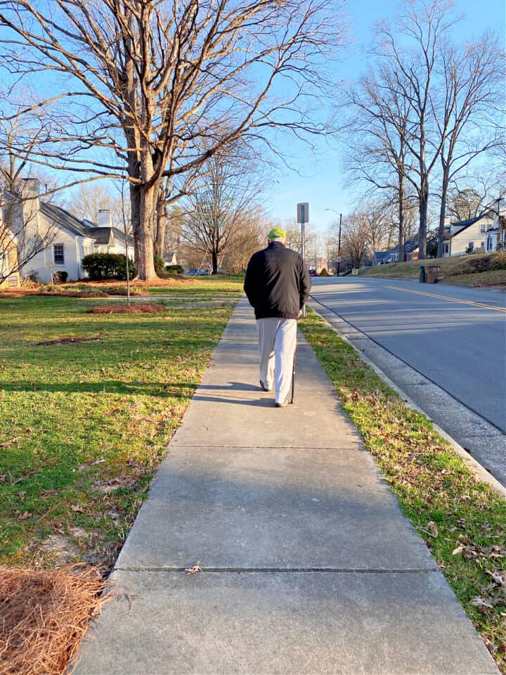 man walking on sidewalk