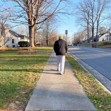 man walking on sidewalk