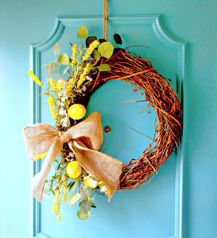 spring wreath hanging on blue door