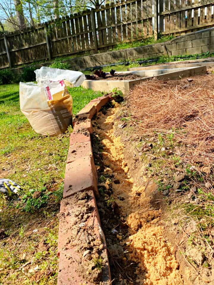 Laying Brick Edging In Your Garden photo paver sand in trench for brick border