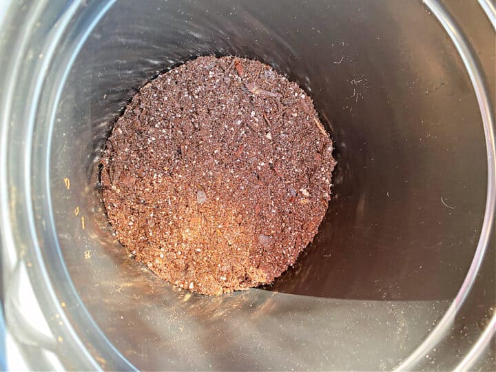 potting soil in bottom of plant pot