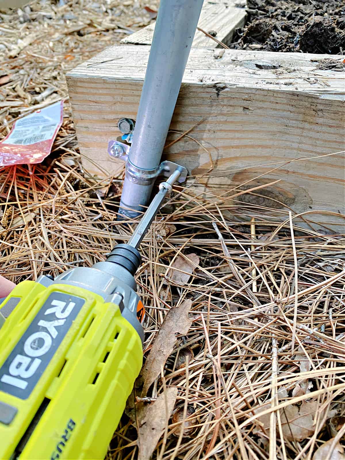 using drill to screw a hole strap on wood