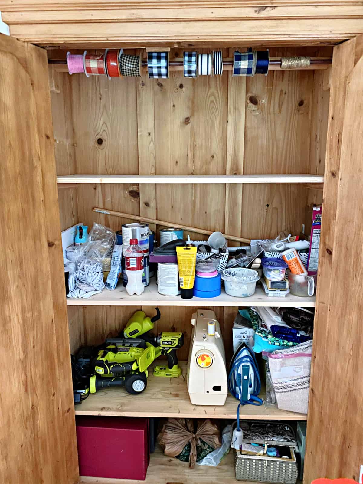shelves with craft supplies in an armoire