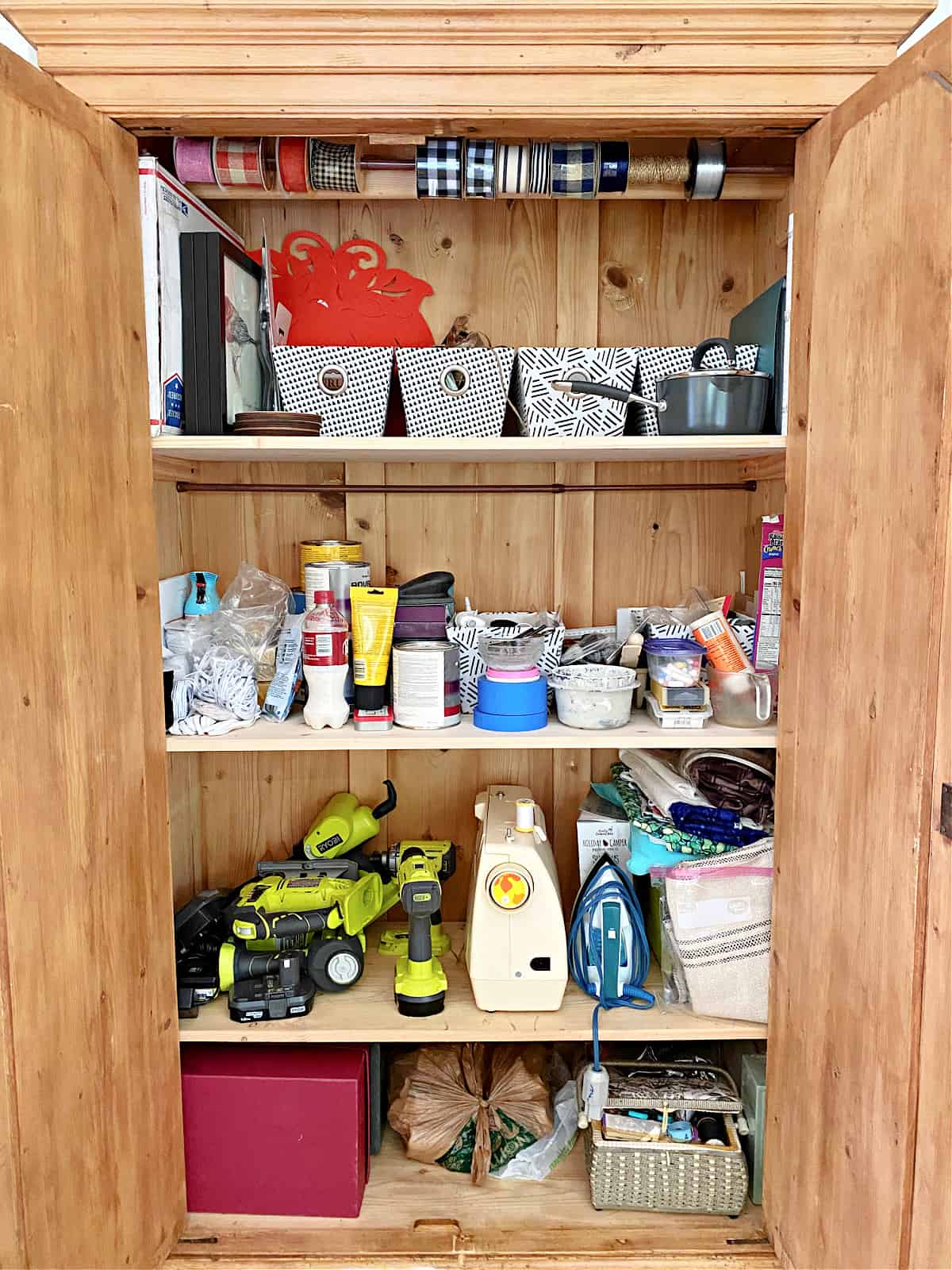 bins and supplies in craft cabinet