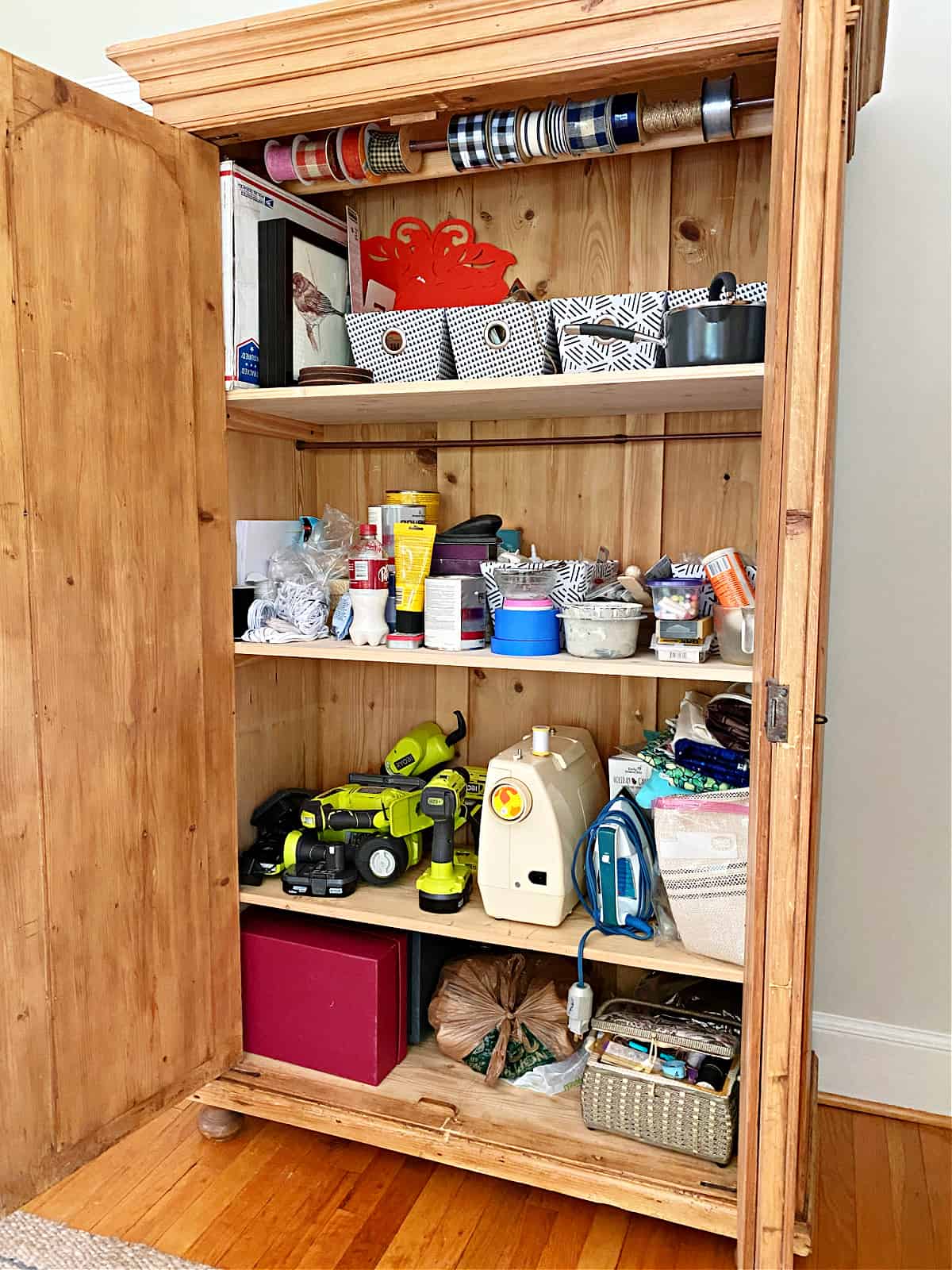 bins and supplies in craft cabinet