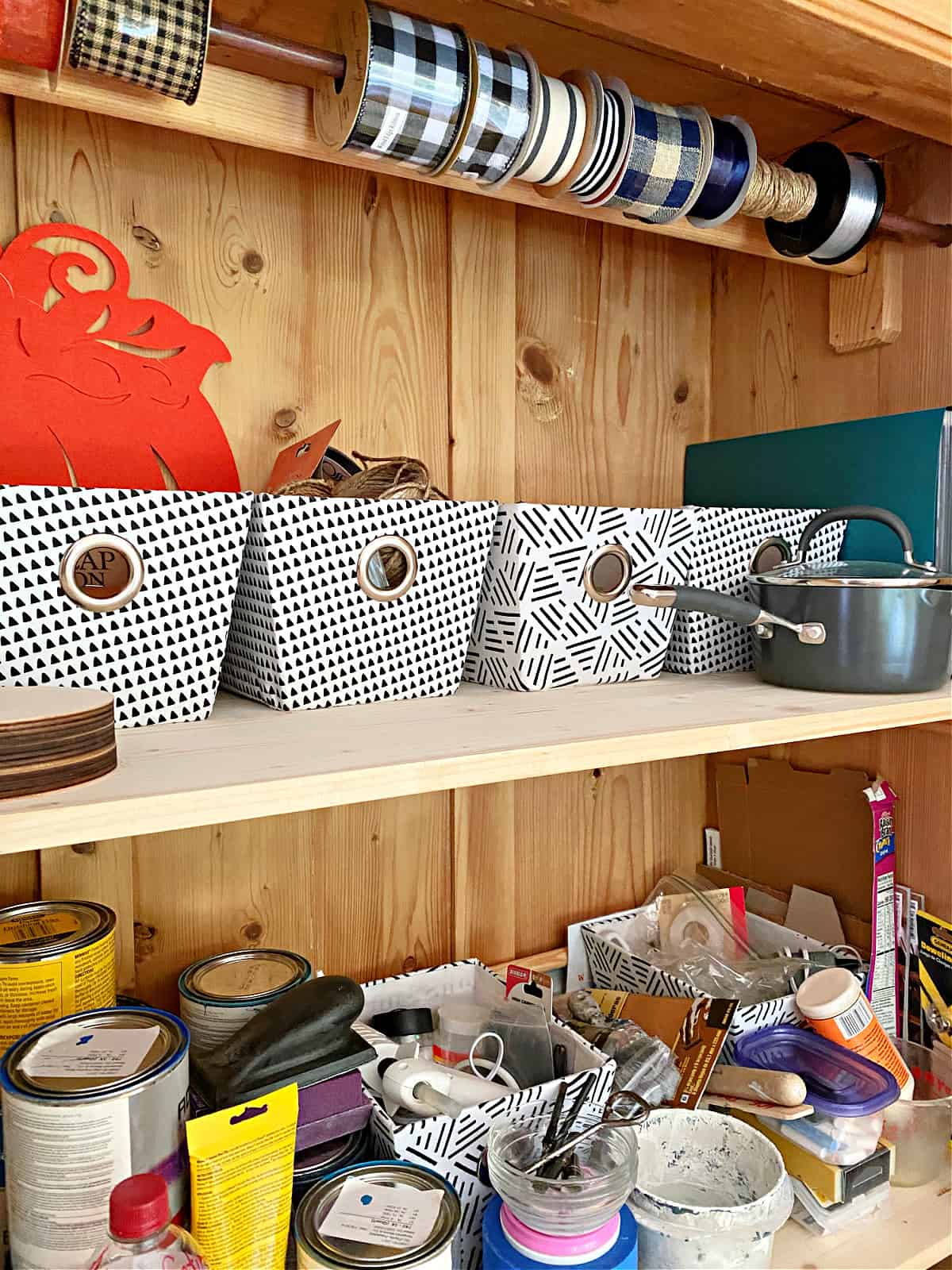 fabric storage bins and supplies in craft cabinet