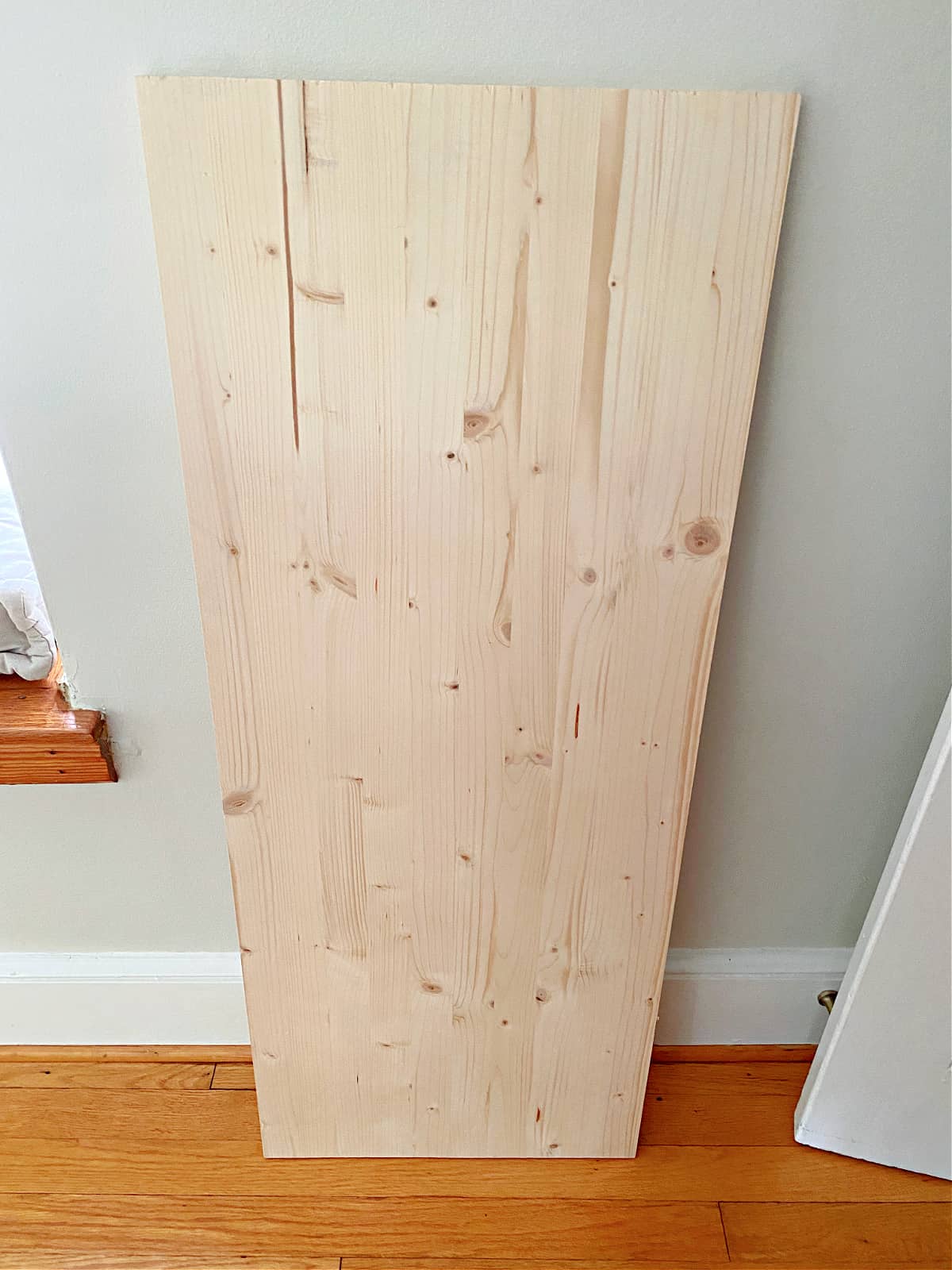 pine board leaning against wall