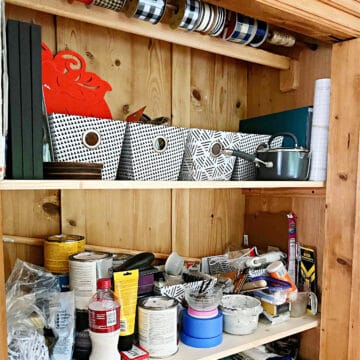 bins and supplies in craft cabinet
