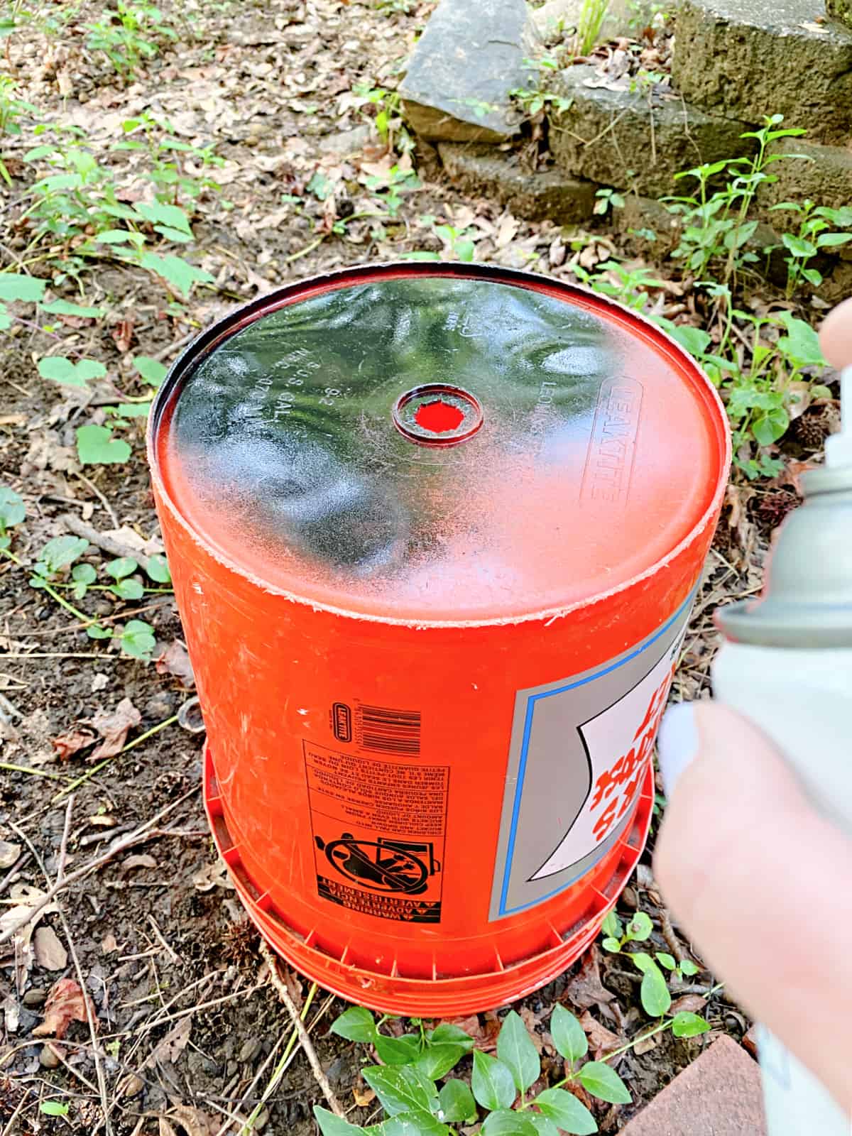 orange bucket with black paint