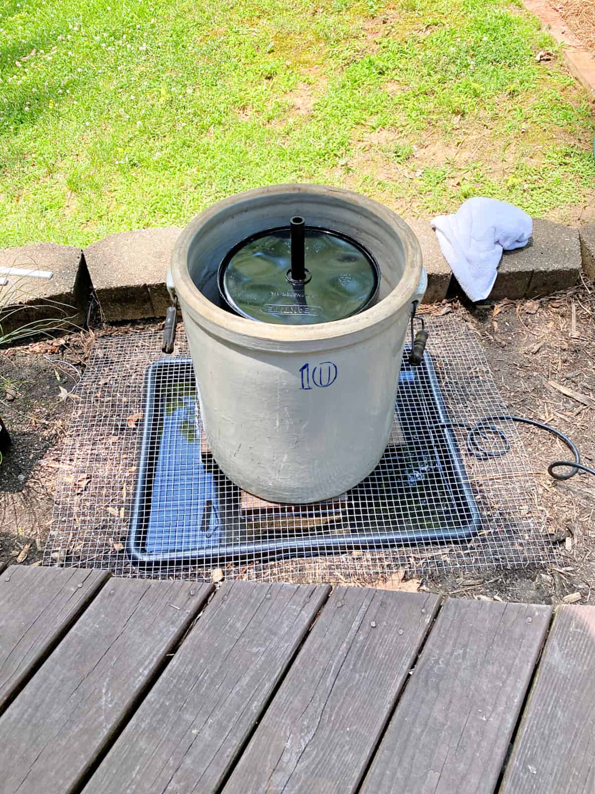 crock fountain in flowerbed