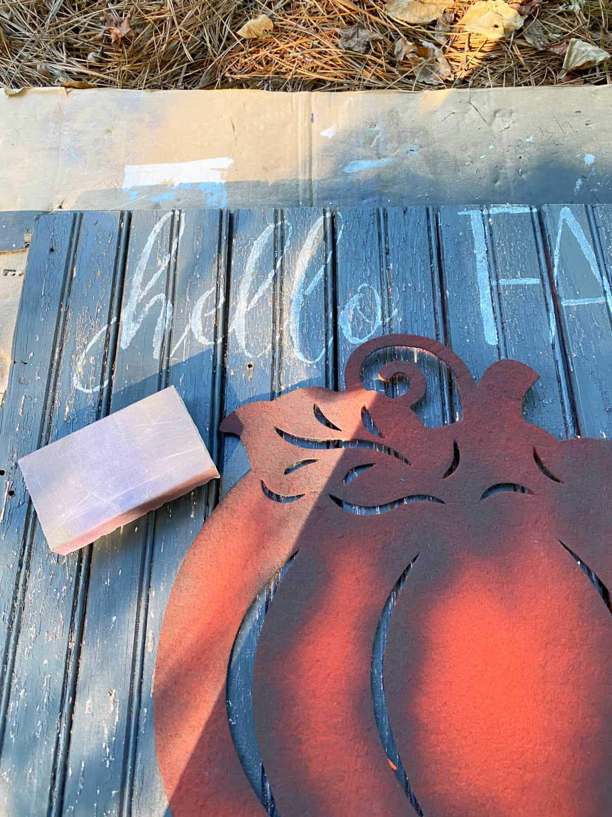 sanding block on fall wood sign