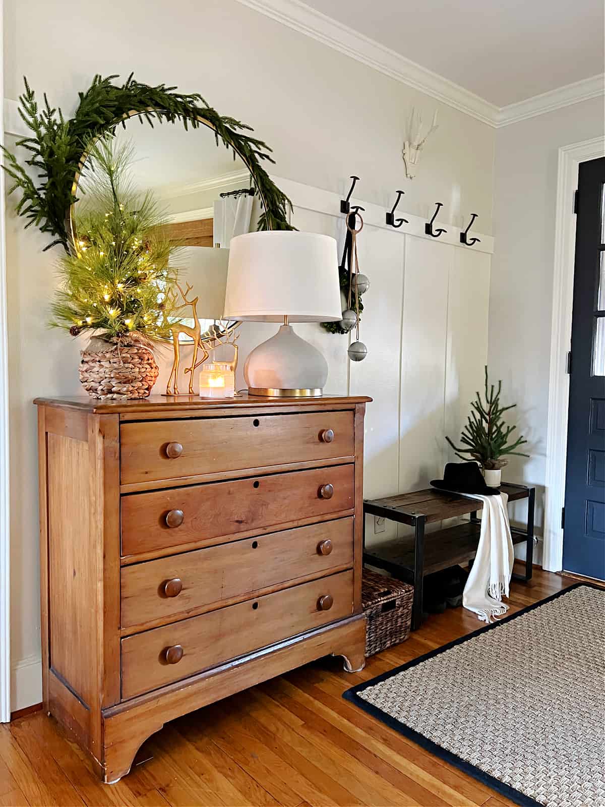 entryway with console and bench decorated for Christmas
