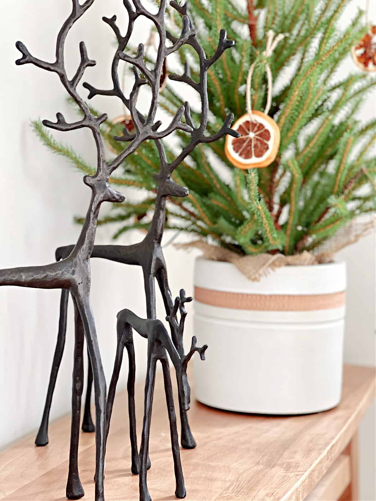 3 metal reindeer on wood bench