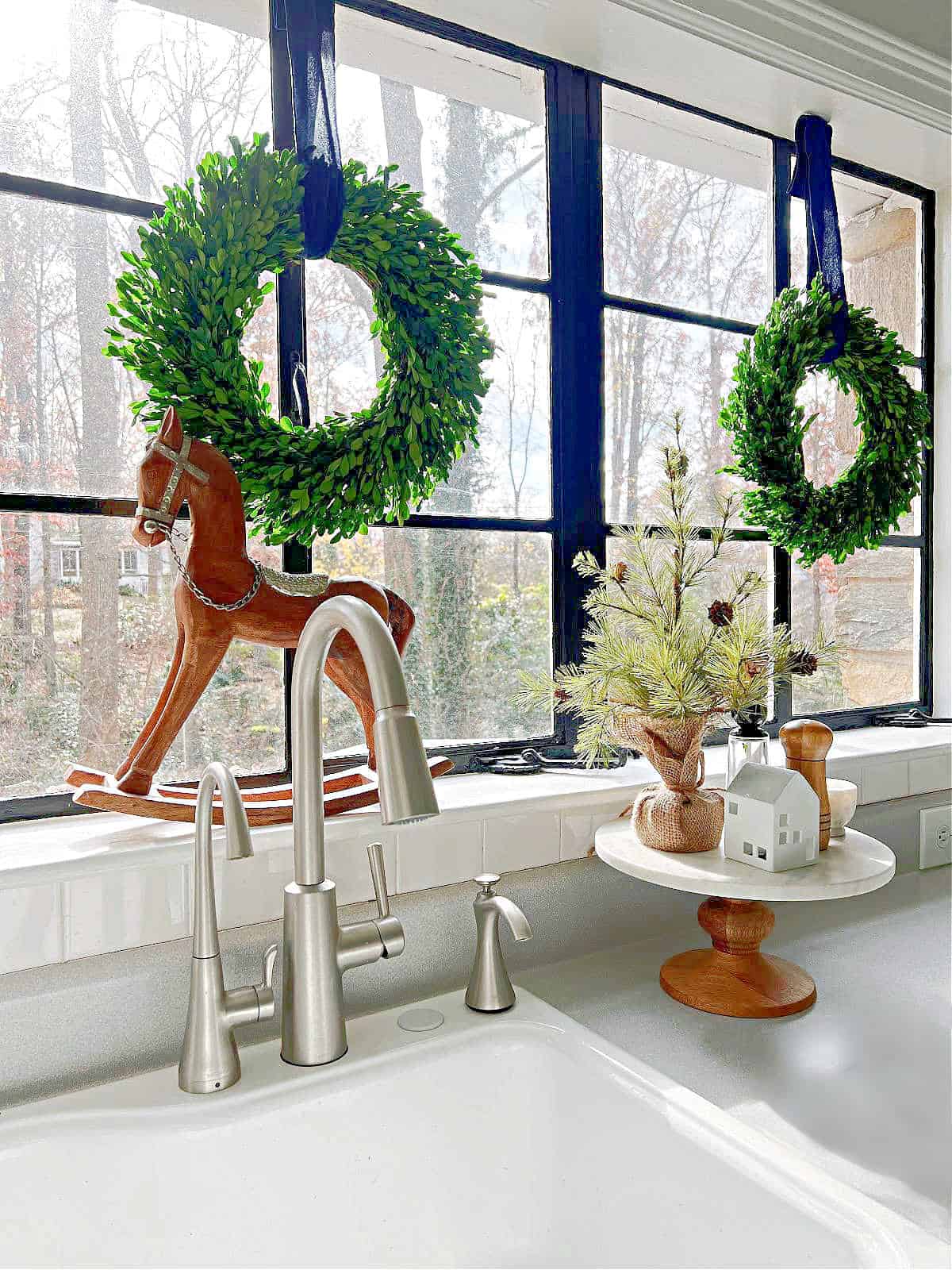 kitchen windowsill with wood rocking forse and window wreaths