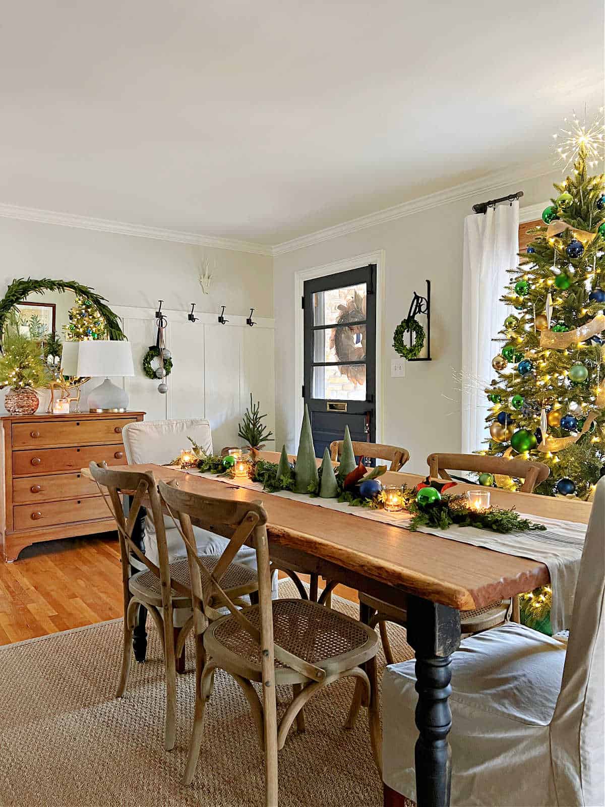 dining room and entryway decorated for Christmas