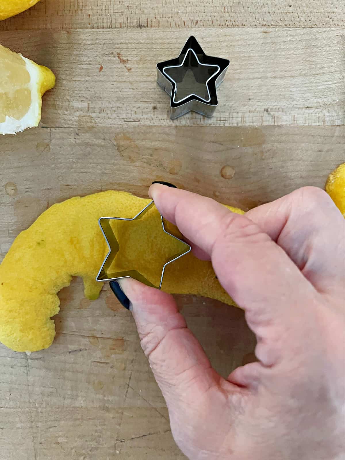 using star cookie cutter to cut lemon peel