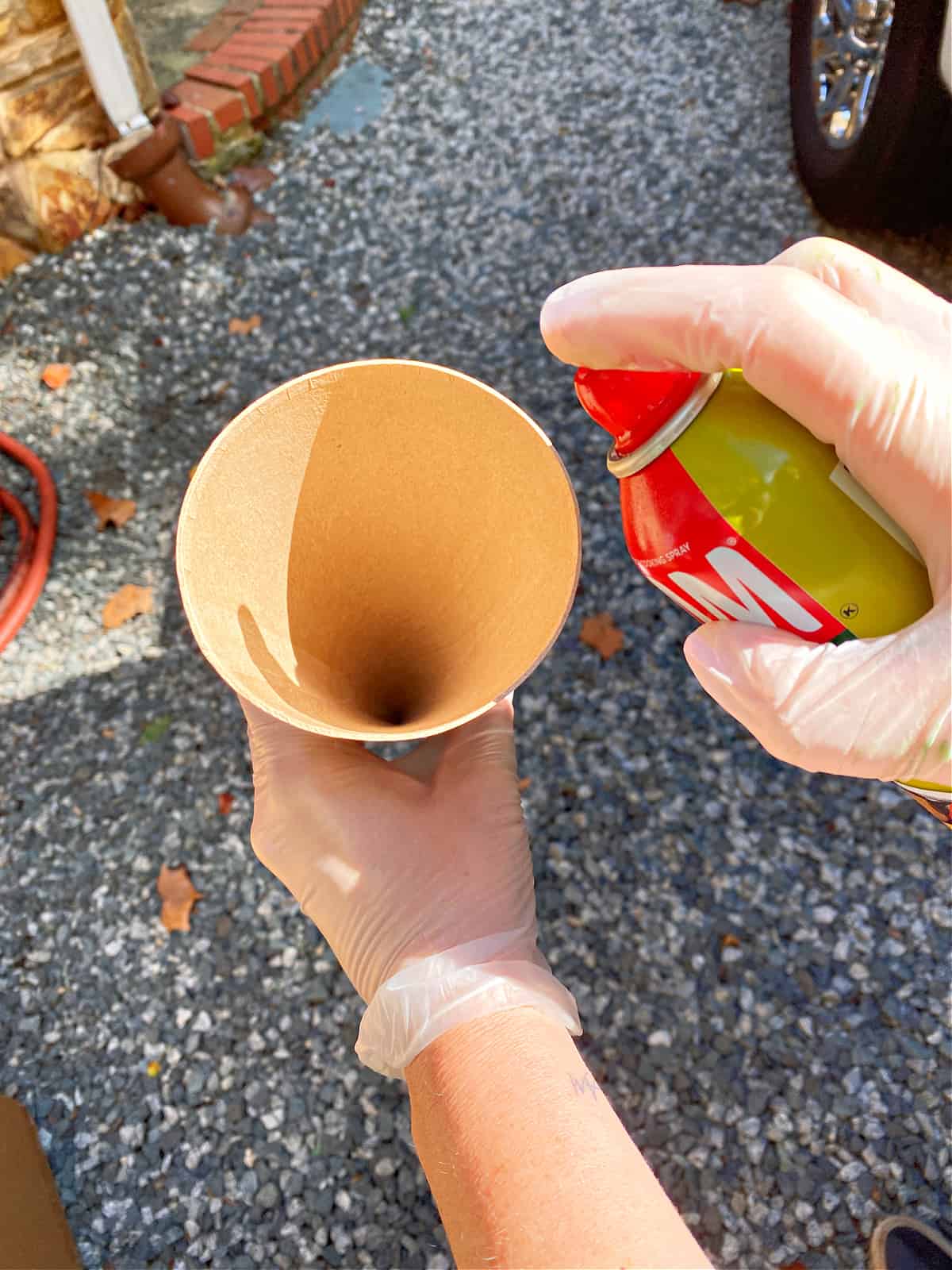 spraying cooking spray in a cardboard cone form