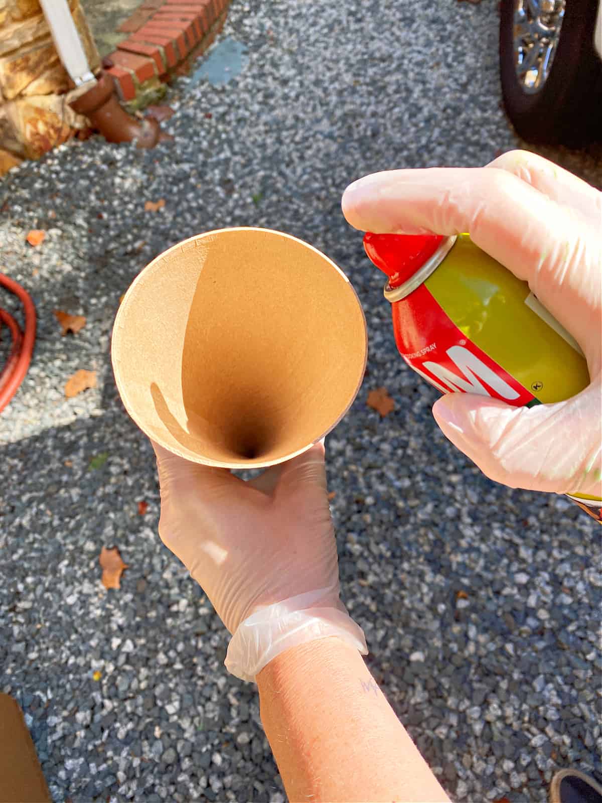 How to Make a Concrete Christmas Tree image spraying cooking spray in a cardboard cone form