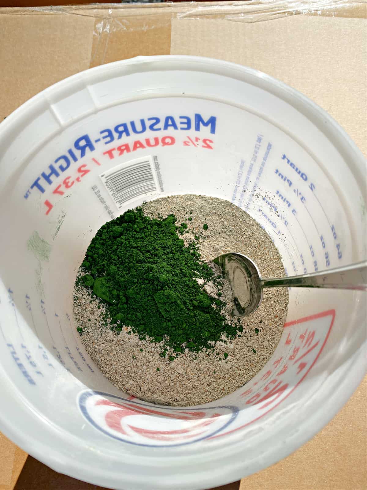 green concrete dye in bowl of concrete mix