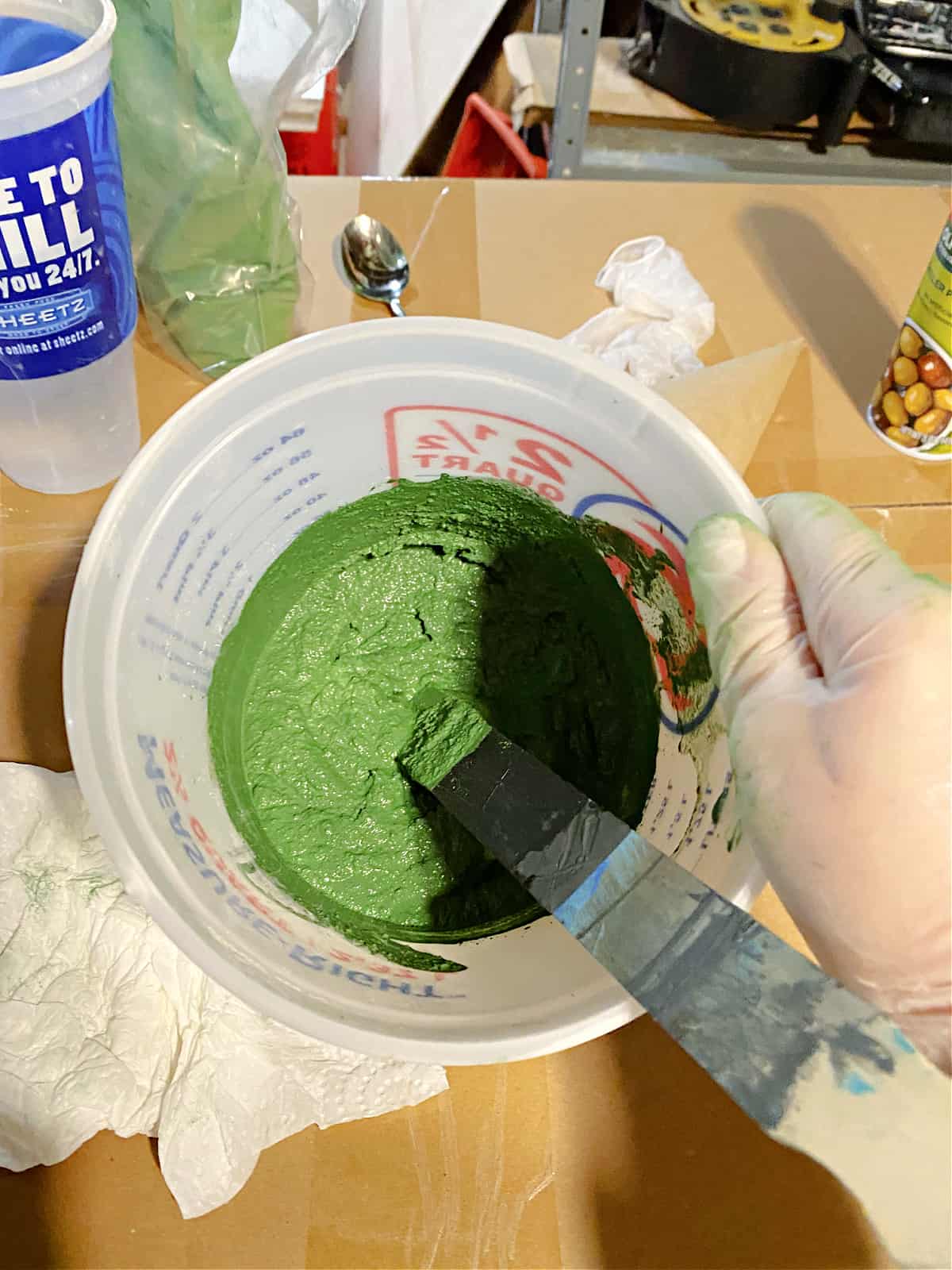 concrete mix and concrete dye mixed in small bucket