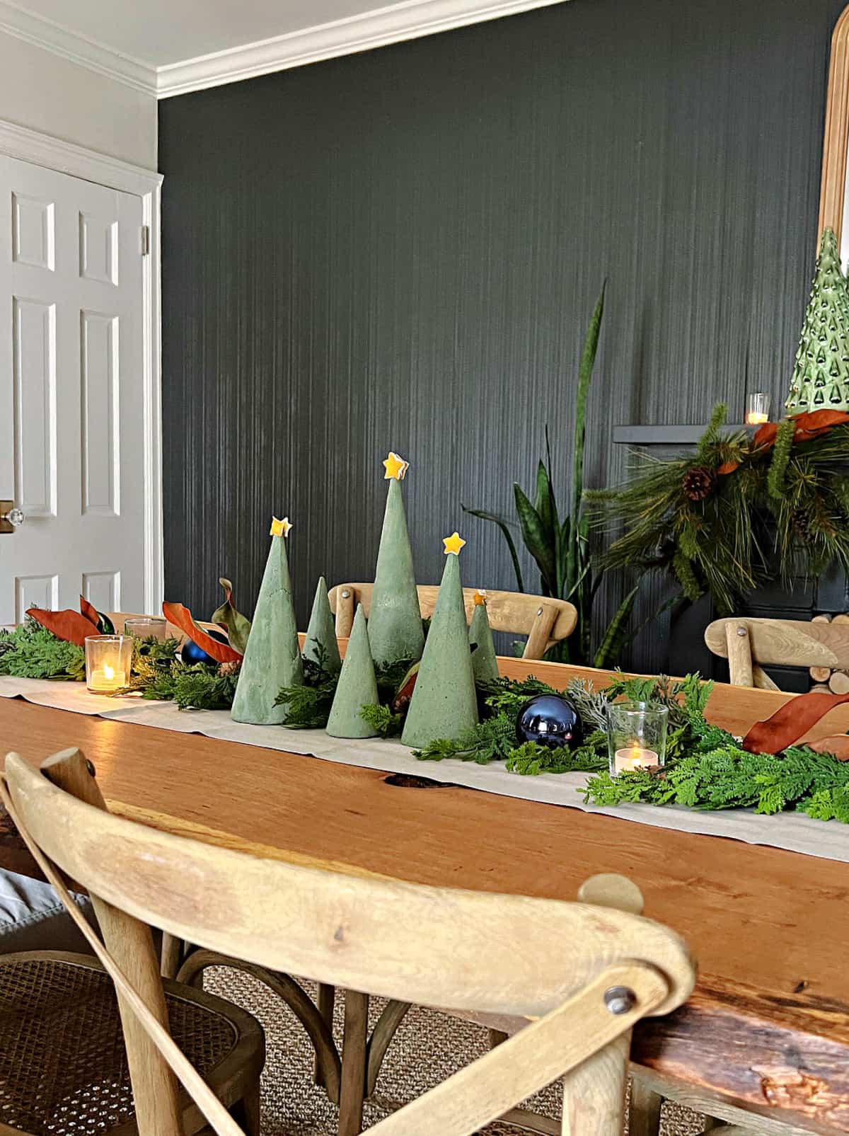 How to Make a Concrete Christmas Tree tabletop view group of green dyed concrete trees on dining room table.