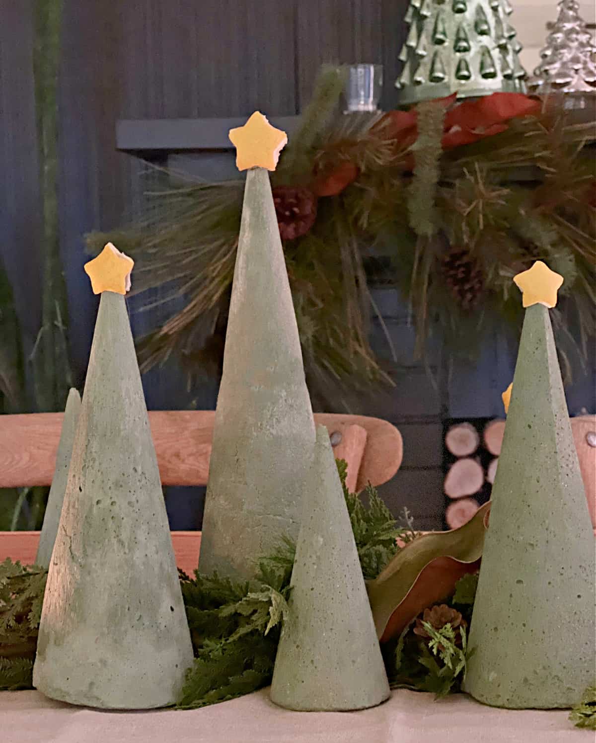 4 green dyed concrete Christmas trees on table