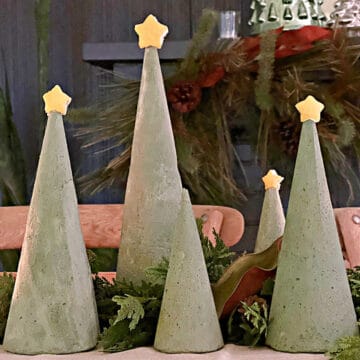 5 green dyed concrete Christmas trees on table
