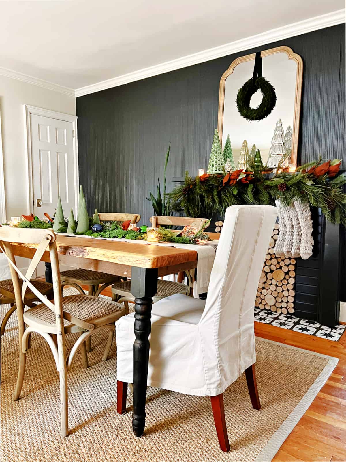 dining room with black painted fireplace wall