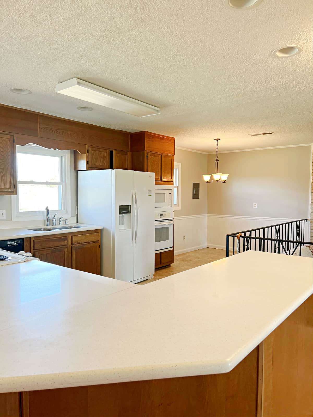 view of kitchen with oak cabinets and white countertops