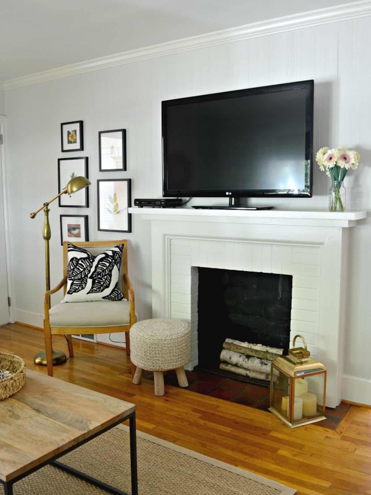 living room fireplace with tv on mantel