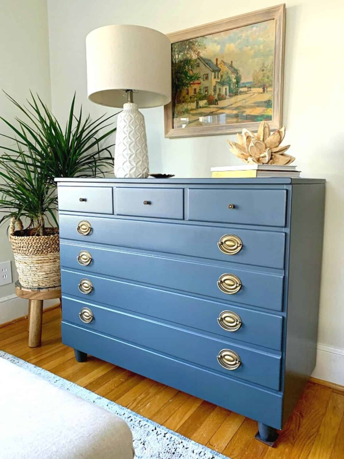 Why Benjamin Moore Hale Navy is a Favorite Paint Color photo GoodWill dresser painted in navy with a white lamp on top
