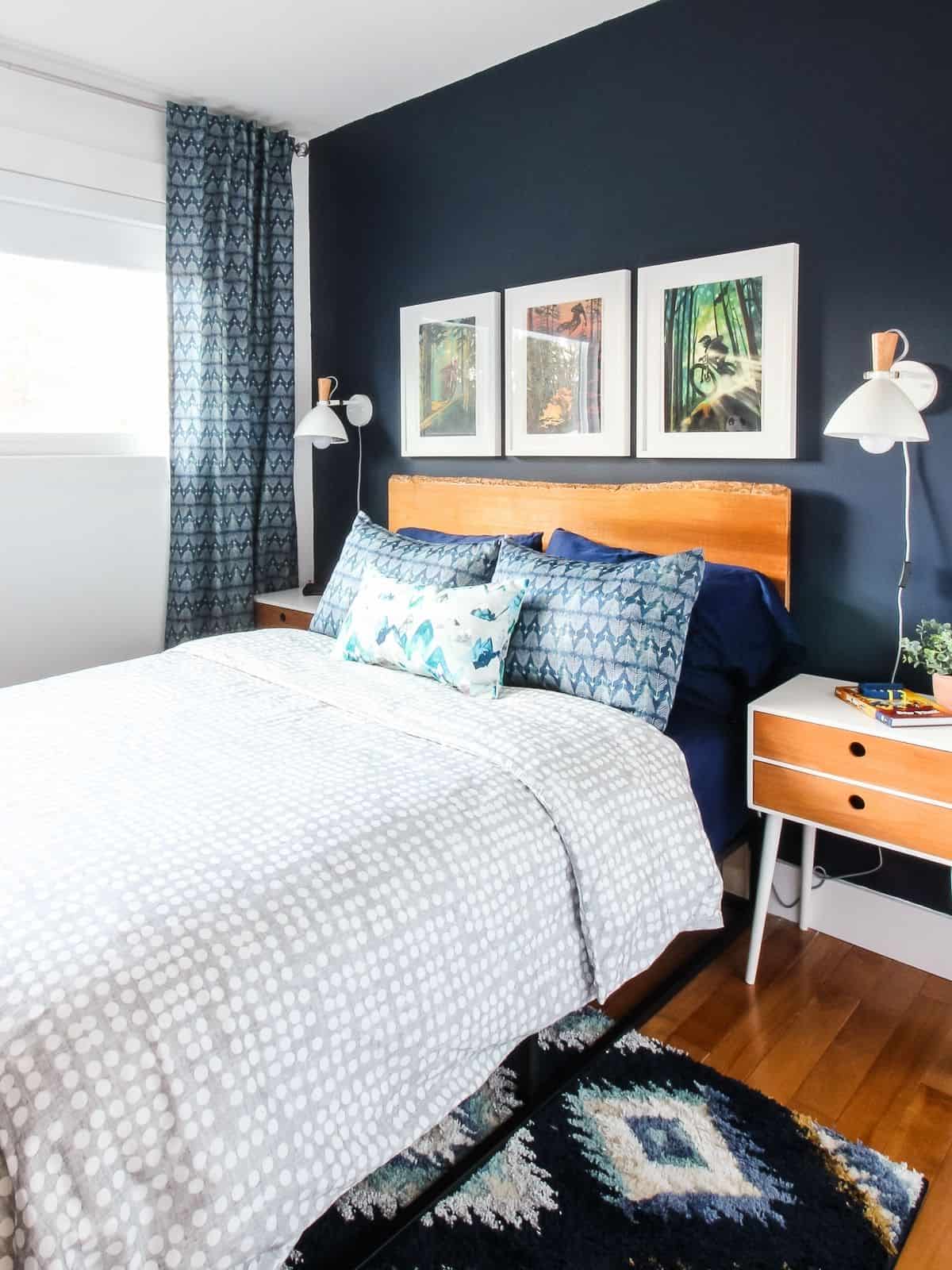 boys bedroom with furniture and navy painted wall
