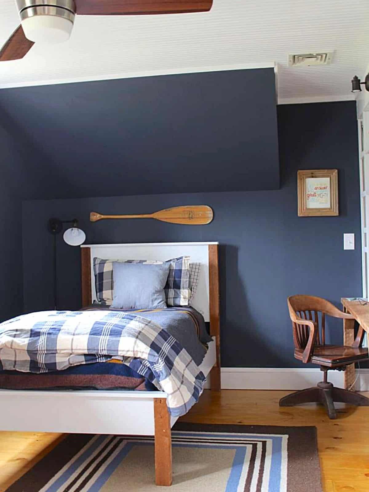boys bedroom with navy blue painted wall