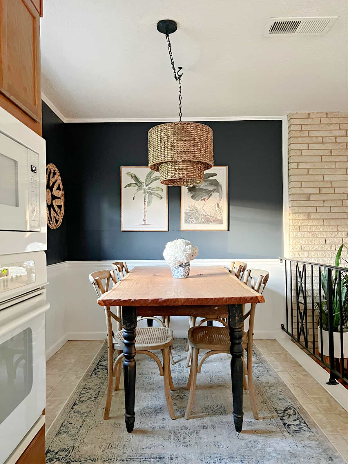 small dining room with navy walls and table and chairs