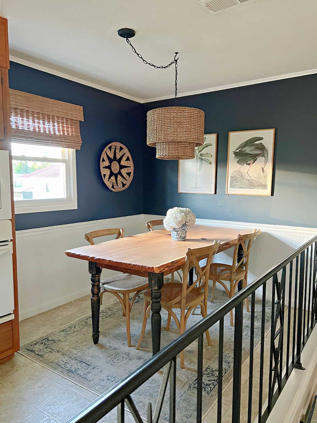 small dining room with navy walls and table and chairs