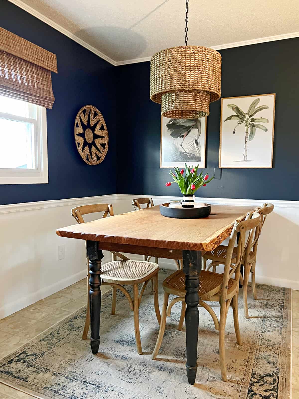 small dining room with navy walls and table and chairs