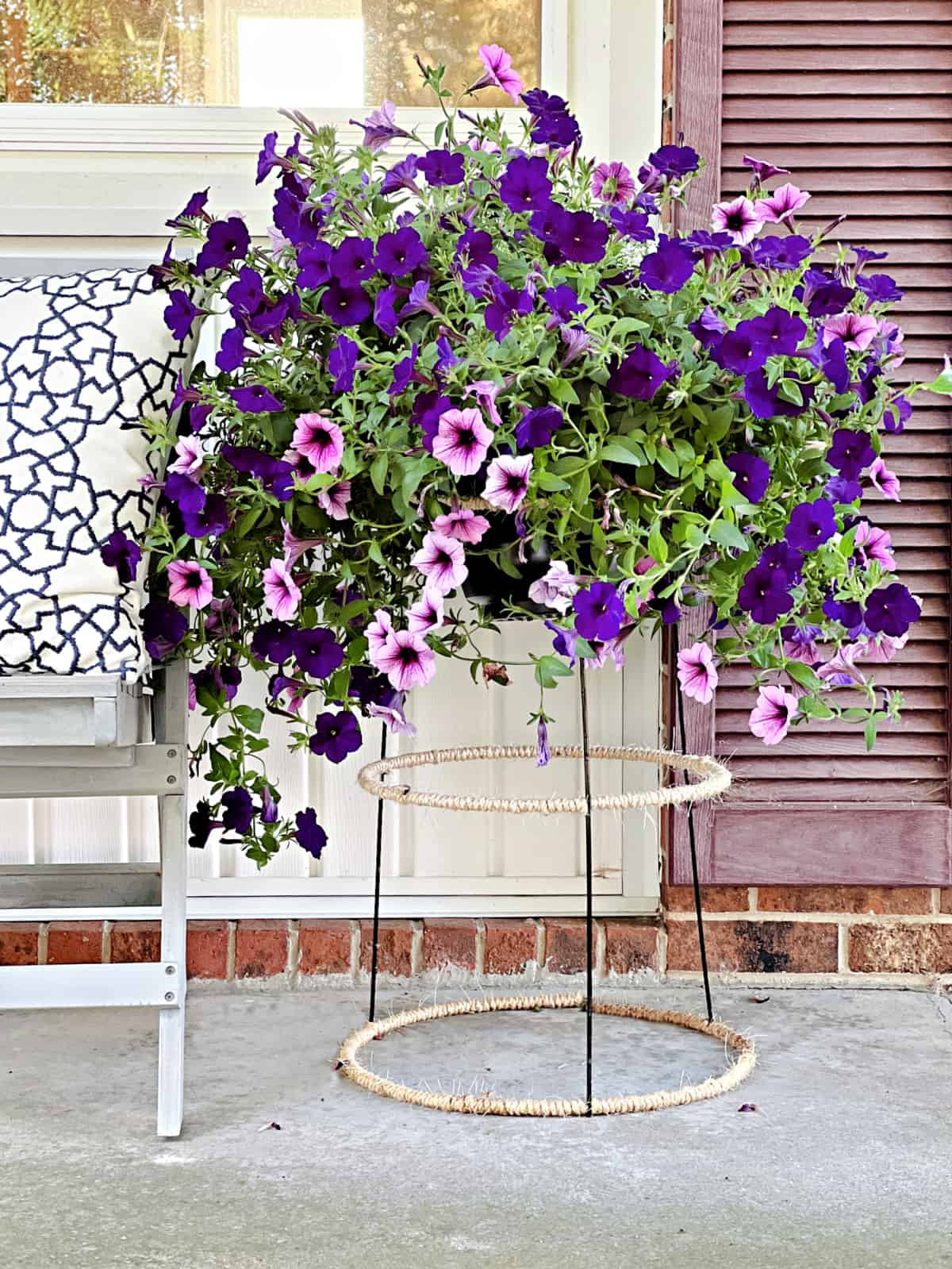 Easy DIY Plant Stand snap purple flowers planted in plant stand on front porch